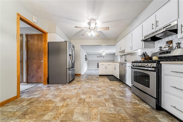 2640 Fleger Dr, Parma, OH 44134 - kitchen featuring stainless steel appliances, under cabinet range hood, a ceiling fan, white cabinetry, and light stone finish flooring