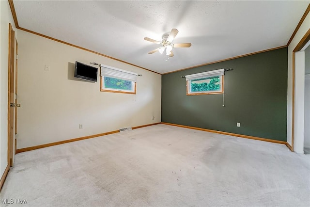2640 Fleger Dr, Parma, OH 44134 - empty room featuring ornamental molding, a ceiling fan, light carpet, and healthy amount of natural light