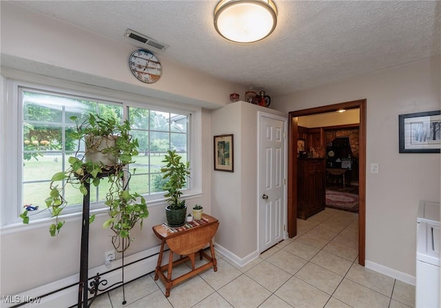 11756 Clarke Rd, Columbia Station, OH 44028 - hall featuring light tile patterned floors, a textured ceiling, and a baseboard heating unit