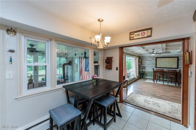 11756 Clarke Rd, Columbia Station, OH 44028 - dining area featuring a chandelier, a ceiling fan, light tile patterned flooring, and a textured ceiling