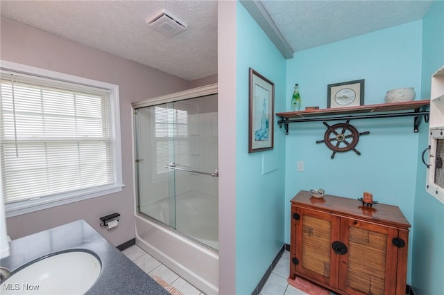 11756 Clarke Rd, Columbia Station, OH 44028 - bathroom featuring tile patterned floors, a textured ceiling, shower / bath combination with glass door, and vanity