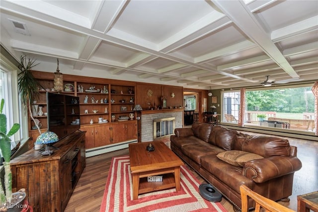 11756 Clarke Rd, Columbia Station, OH 44028 - living room with baseboard heating, coffered ceiling, wood finished floors, a brick fireplace, and beamed ceiling