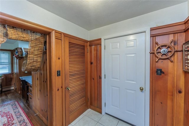 11756 Clarke Rd, Columbia Station, OH 44028 - foyer entrance featuring a baseboard radiator and light tile patterned floors