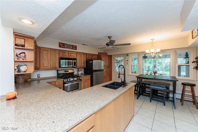 11756 Clarke Rd, Columbia Station, OH 44028 - kitchen featuring appliances with stainless steel finishes, brown cabinets, light tile patterned flooring, a ceiling fan, and a chandelier