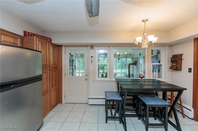 11756 Clarke Rd, Columbia Station, OH 44028 - dining room with a chandelier, light tile patterned floors, baseboard heating, and a textured ceiling