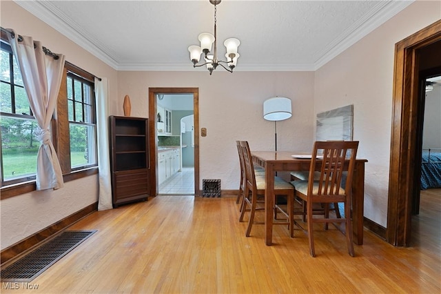 4019 Euclid Blvd, Youngstown, OH 44512 - dining space with light wood-style floors, a chandelier, and crown molding