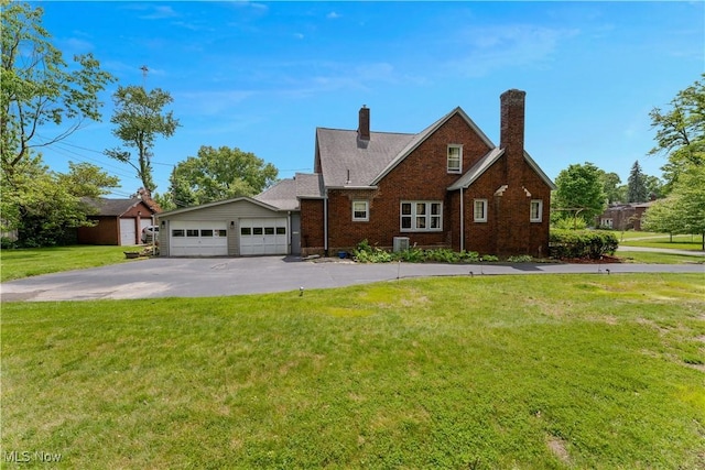 4019 Euclid Blvd, Youngstown, OH 44512 - view of front facade with a front lawn, brick siding, and a chimney