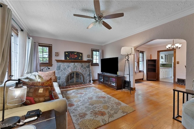 4019 Euclid Blvd, Youngstown, OH 44512 - living area featuring wood finished floors, ceiling fan, a textured ceiling, a chandelier, and arched walkways