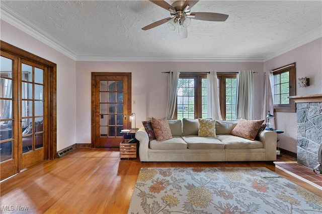 4019 Euclid Blvd, Youngstown, OH 44512 - living area featuring light wood-type flooring, ornamental molding, a ceiling fan, a textured ceiling, and french doors