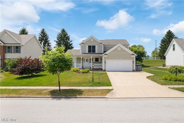 3100 Ravineview Cir, Stow, OH 44224 - traditional-style house with concrete driveway, covered porch, a front lawn, and a garage