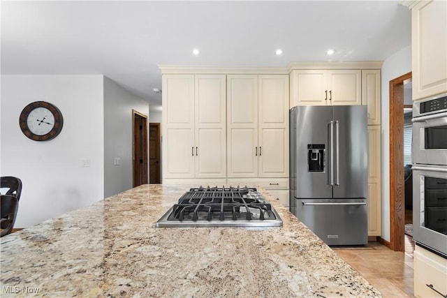 3100 Ravineview Cir, Stow, OH 44224 - kitchen with stainless steel appliances, cream cabinetry, light stone counters, and recessed lighting