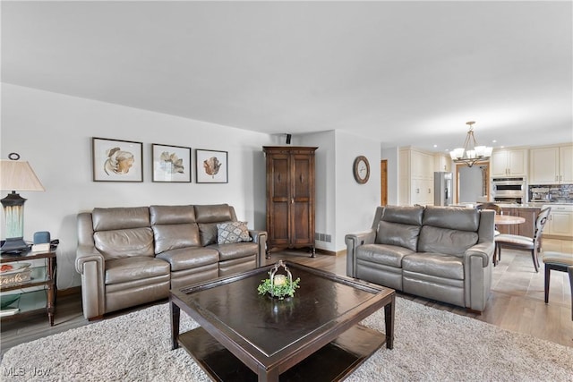 3100 Ravineview Cir, Stow, OH 44224 - living area with a chandelier and light wood-style flooring