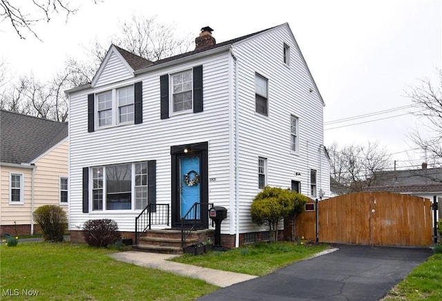 3921 Grosvenor Rd, South Euclid, OH 44118 - view of front facade with a chimney and a gate