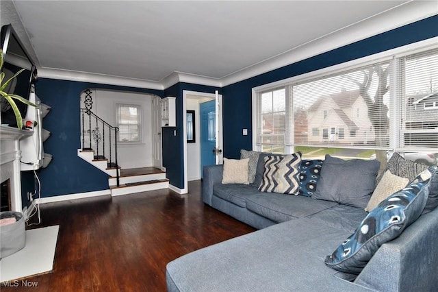 3921 Grosvenor Rd, South Euclid, OH 44118 - living area featuring wood finished floors, healthy amount of natural light, stairway, crown molding, and a fireplace with raised hearth