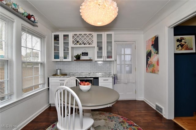 3921 Grosvenor Rd, South Euclid, OH 44118 - dining area with a dry bar, dark wood finished floors, and wine cooler