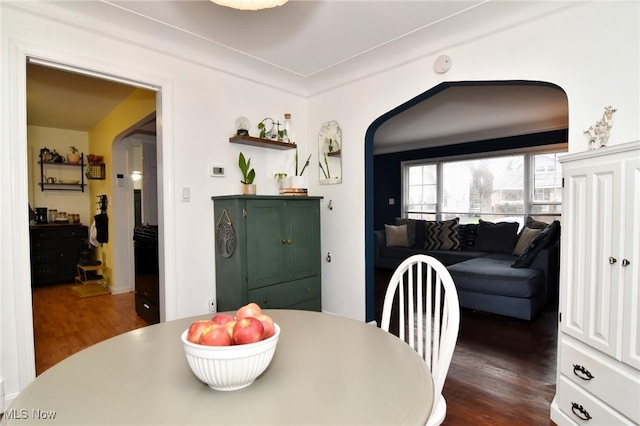 3921 Grosvenor Rd, South Euclid, OH 44118 - dining room with arched walkways and dark wood-type flooring