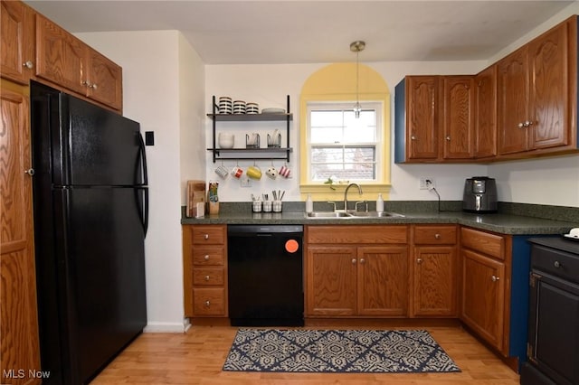 3921 Grosvenor Rd, South Euclid, OH 44118 - kitchen featuring black appliances, light wood-type flooring, dark countertops, and brown cabinets