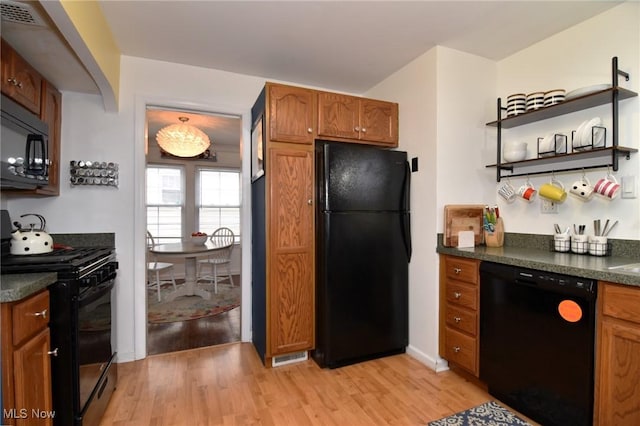 3921 Grosvenor Rd, South Euclid, OH 44118 - kitchen featuring black appliances, dark countertops, light wood-type flooring, brown cabinetry, and open shelves