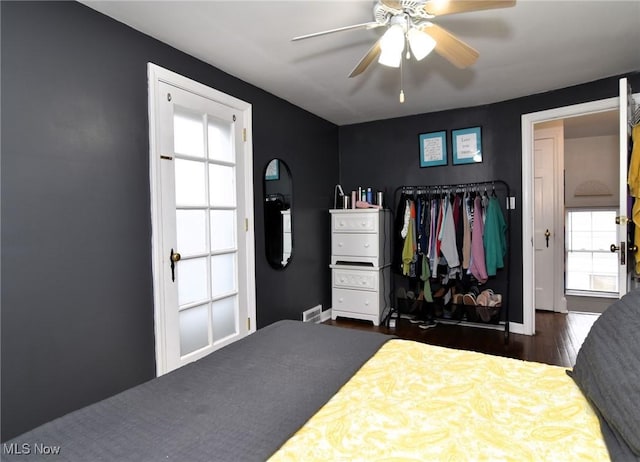 3921 Grosvenor Rd, South Euclid, OH 44118 - bedroom with multiple windows, dark wood-style floors, and ceiling fan