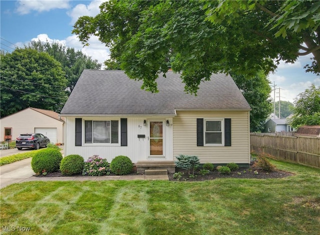87 Holcomb Ave, Mogadore, OH 44260 - cape cod-style house with a shingled roof and a detached garage