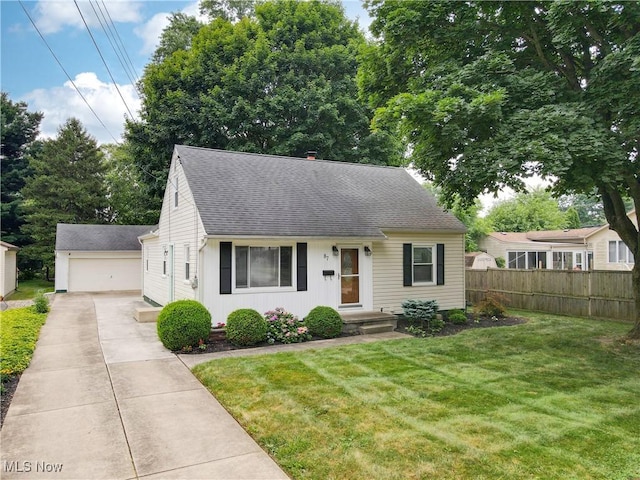 87 Holcomb Ave, Mogadore, OH 44260 - new england style home featuring an outdoor structure and a shingled roof