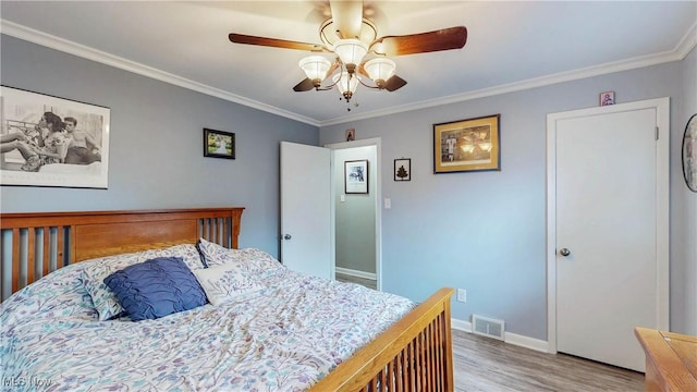 87 Holcomb Ave, Mogadore, OH 44260 - bedroom with wood finished floors, crown molding, and a ceiling fan