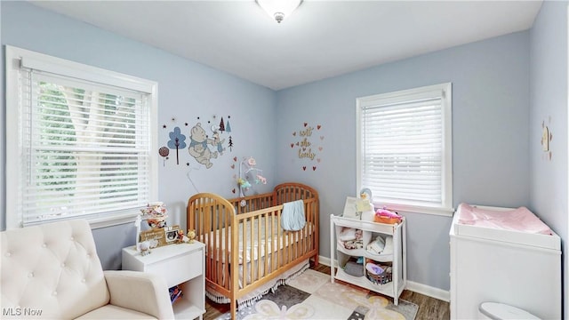 87 Holcomb Ave, Mogadore, OH 44260 - bedroom featuring a nursery area and wood finished floors