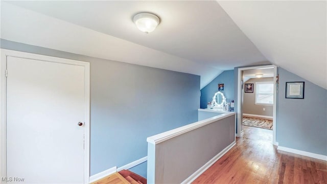 87 Holcomb Ave, Mogadore, OH 44260 - hall featuring an upstairs landing, light wood finished floors, and vaulted ceiling