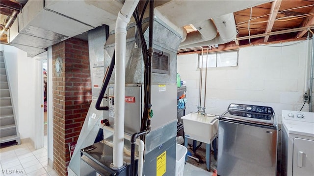 87 Holcomb Ave, Mogadore, OH 44260 - below grade area with washing machine and clothes dryer, stairs, heating unit, and light tile patterned floors