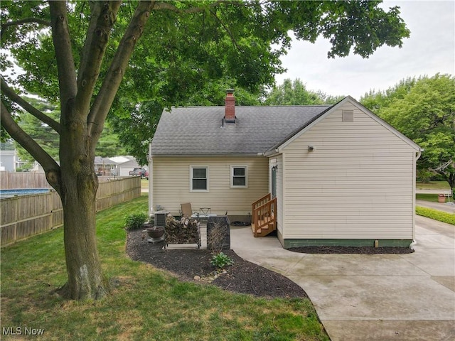 87 Holcomb Ave, Mogadore, OH 44260 - rear view of property with entry steps, a chimney, a patio, and a shingled roof
