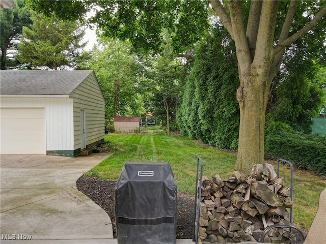 87 Holcomb Ave, Mogadore, OH 44260 - view of grassy yard with a garage and an outdoor structure