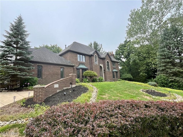 23547 Quail Holw, Westlake, OH 44145 - view of front of home featuring brick siding and a front yard
