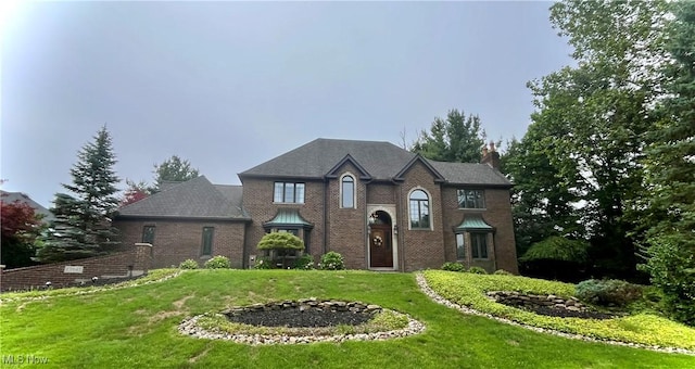 23547 Quail Holw, Westlake, OH 44145 - view of front of property featuring a front lawn, a chimney, and brick siding