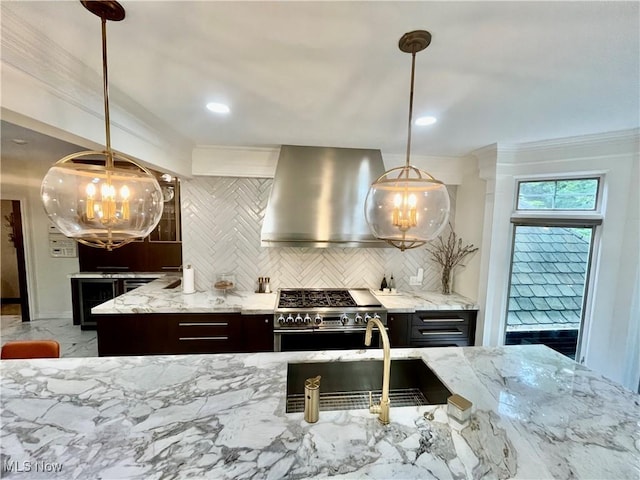 23547 Quail Holw, Westlake, OH 44145 - kitchen with double oven range, wall chimney exhaust hood, a chandelier, decorative backsplash, and light stone counters