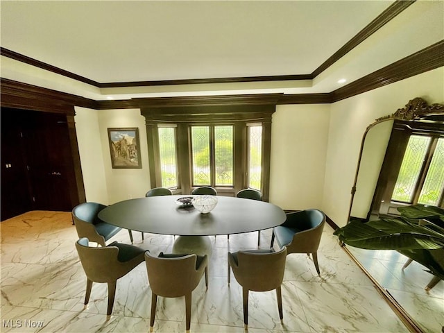 23547 Quail Holw, Westlake, OH 44145 - dining space featuring ornamental molding, healthy amount of natural light, a tray ceiling, and marble finish flooring