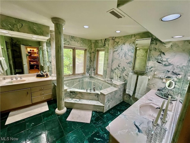 23547 Quail Holw, Westlake, OH 44145 - full bath featuring double vanity, a jetted tub, recessed lighting, wallpapered walls, and decorative columns
