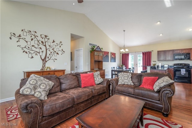 4504 Ledge Ct, Kent, OH 44240 - living room featuring wood finished floors, a chandelier, a ceiling fan, and high vaulted ceiling