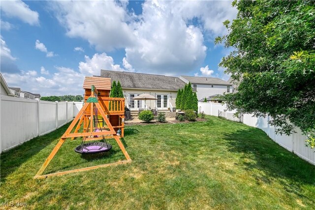 4504 Ledge Ct, Kent, OH 44240 - back of property featuring a playground, french doors, and a fenced backyard