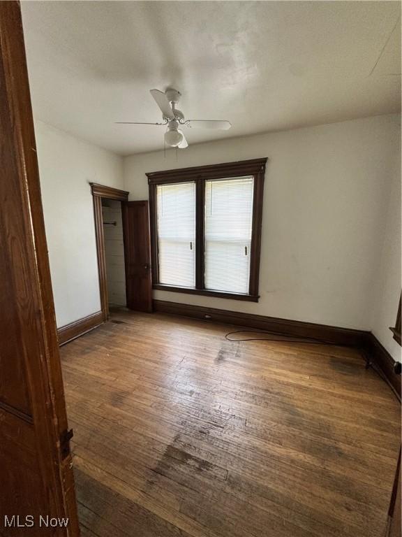 699 E 156th St, Cleveland, OH 44110 - unfurnished bedroom featuring wood finished floors and ceiling fan