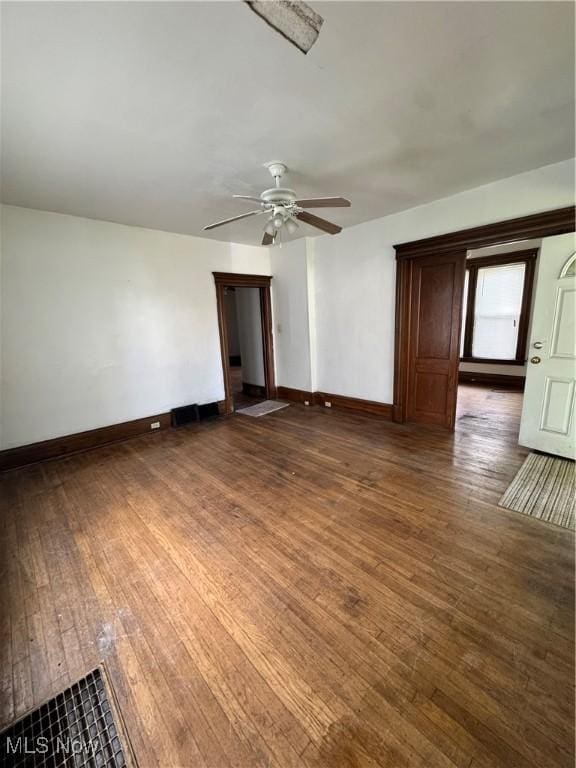 699 E 156th St, Cleveland, OH 44110 - spare room with dark wood-style floors and ceiling fan