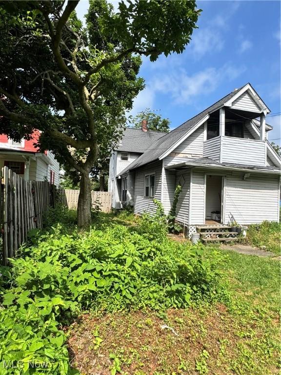 699 E 156th St, Cleveland, OH 44110 - view of side of property with a chimney