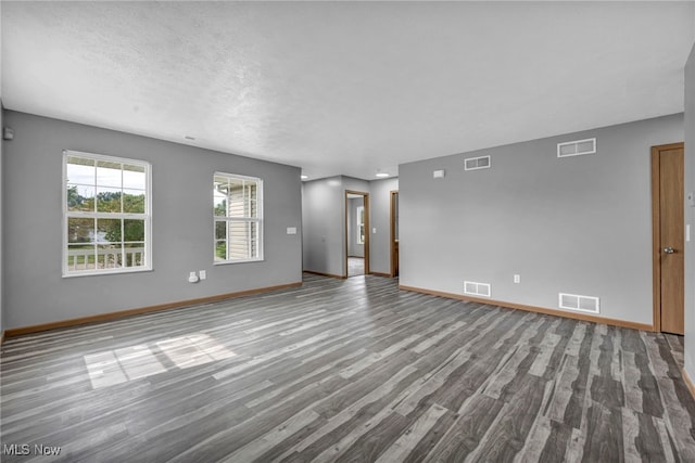 1350 Elmside St, Alliance, OH 44601 - spare room with wood finished floors and a textured ceiling