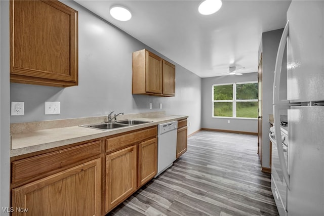 1350 Elmside St, Alliance, OH 44601 - kitchen featuring white appliances, light wood-type flooring, light countertops, ceiling fan, and brown cabinetry