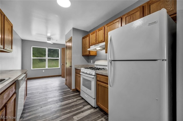 1350 Elmside St, Alliance, OH 44601 - kitchen with white appliances, under cabinet range hood, wood finished floors, brown cabinetry, and light countertops
