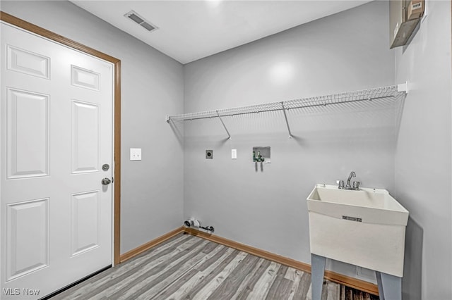1350 Elmside St, Alliance, OH 44601 - laundry room with light wood-type flooring, electric dryer hookup, and washer hookup