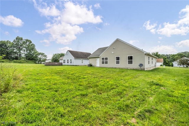 1350 Elmside St, Alliance, OH 44601 - back of house featuring a lawn