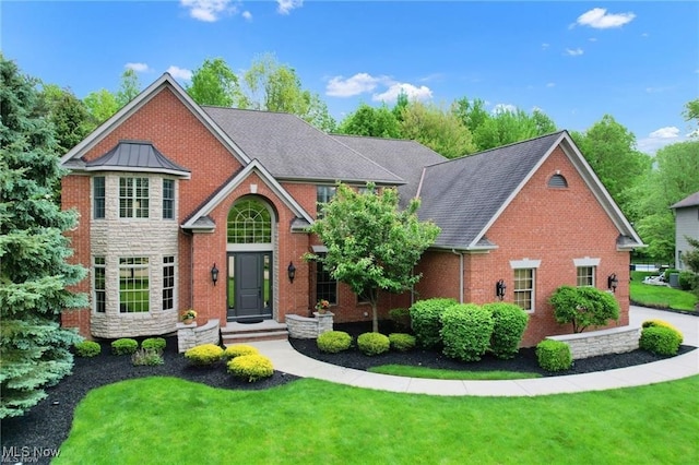 32305 Monaco Pl, Avon Lake, OH 44012 - traditional-style home featuring a front lawn, a standing seam roof, brick siding, and stone siding