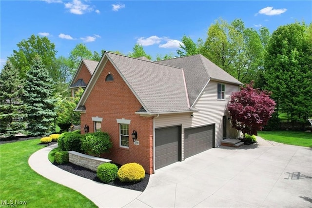 32305 Monaco Pl, Avon Lake, OH 44012 - view of side of home with driveway, brick siding, a yard, an attached garage, and a shingled roof