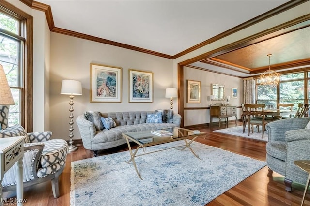 32305 Monaco Pl, Avon Lake, OH 44012 - living area with healthy amount of natural light, a chandelier, wood finished floors, and ornamental molding