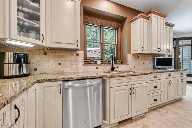 32305 Monaco Pl, Avon Lake, OH 44012 - kitchen featuring stainless steel dishwasher, light stone counters, backsplash, and glass insert cabinets